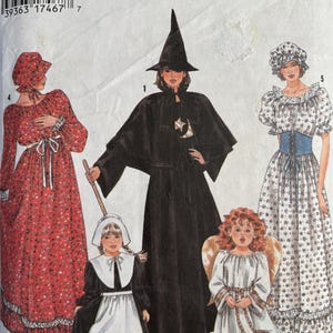 May include: A Simplicity sewing pattern envelope 9982 featuring illustrations of five costumes: a red floral dress with a bonnet, a black witch costume with a pointed hat, a white angel dress with wings, a colonial-style dress, and a floral dress.