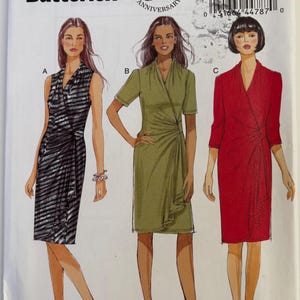 May include: Butterick sewing pattern B5862 for a wrap dress with three variations: a sleeveless black and gray striped version, a short-sleeved olive green version, and a red version with three-quarter sleeves. Includes size range 18W-24W.
