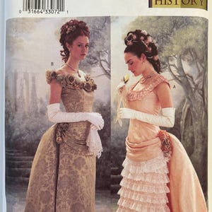May include: Butterick sewing pattern 3012, size 6, 8, 10, featuring two gown designs. View B is a gold damask dress with off-shoulder floral accents. View A is a peach dress with a tiered lace skirt, ruffled bodice, and a long train.