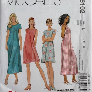 May include: A McCall's M6102 sewing pattern envelope for a 1 Hour Dress. The front displays four illustrations of dresses in different lengths and fabrics: a solid teal maxi, a solid coral knee-length, a floral print, and a pink and white gingham.