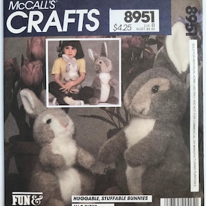 May include: A sewing pattern for two huggable,  stuffable bunnies. The pattern is from McCall's Crafts and is for two sizes. The pattern number is 8951.