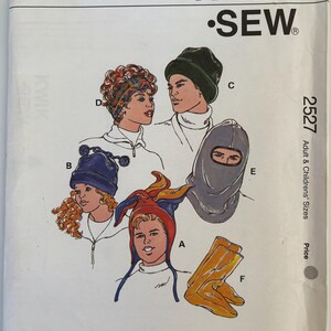 May include: A Kwik Sew pattern envelope 2527 for hats and socks in adult and children's sizes. The cover features illustrations of various headwear styles labeled A through E, including a multi-colored hat, a blue pom-pom hat, and a grey balaclava.