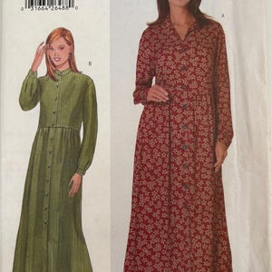 May include: Butterick sewing pattern 5239 for sizes 12-14-16. The envelope displays two long-sleeved, button-front dress variations: one in a solid olive green fabric and another in a red fabric featuring a small white floral print pattern.