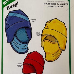 May include: A sewing pattern envelope for The Green Pepper Inc. F893 Tuck-Away Balaclava. The cover features illustrations of a blue striped balaclava, a yellow solid color balaclava, and a red solid color hat. Text includes Easy!, Multi-sized for adults, and instructions for three ways to wear the facemask.