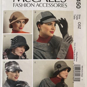 May include: McCall's M6450 fashion accessories sewing pattern envelope featuring illustrations of five different hat styles and gloves. The designs include a tan cloche with a bow, a grey newsboy cap, a dark grey hat with bows, a plaid cap, and a grey hat with a flower.