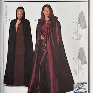 May include: A Burda Easy sewing pattern envelope for a cape, model 2566. The front displays two variations: a black hooded cape and a deep burgundy cape with a collar. Technical line drawings show the cape silhouettes, and text includes sizes.