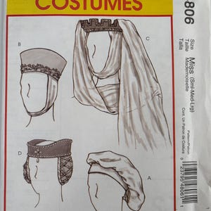 May include: A McCall's Costumes sewing pattern envelope M4806 featuring illustrations of four different headpieces labeled A, B, C, and D. The white envelope includes a yellow header with red text and displays various styles of hats and veils for costumes.