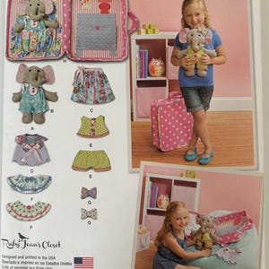 May include: Simplicity sewing pattern 1238 for a stuffed elephant toy and various doll clothing items including dresses, skirts, shorts, and bows. The package features illustrations of the finished items and a pink polka dot carrying case.