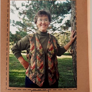 May include: A sewing pattern booklet titled Prairie Braid Vest #130 Patchworks. The cover features a photograph of a vest with a multi-colored, diagonal woven-look pattern in shades of red, green, yellow, and brown, worn over a dark green shirt.