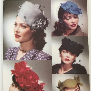 May include: A Vogue Accessories sewing pattern envelope 7325 featuring five distinct hat designs labeled A through E. The cover displays a light gray hat with floral accents, a blue hat with netting, a black hat, a red hat with large floral details, and a small green hat with leaf-like side embellishments.