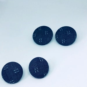 May include: Three blue fabric buttons with a white geometric pattern.