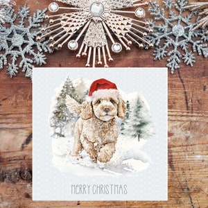 May include: A Christmas card featuring a cute, light brown dog wearing a red Santa hat and running through a snowy winter scene. The card has the text "Merry Christmas" at the bottom.