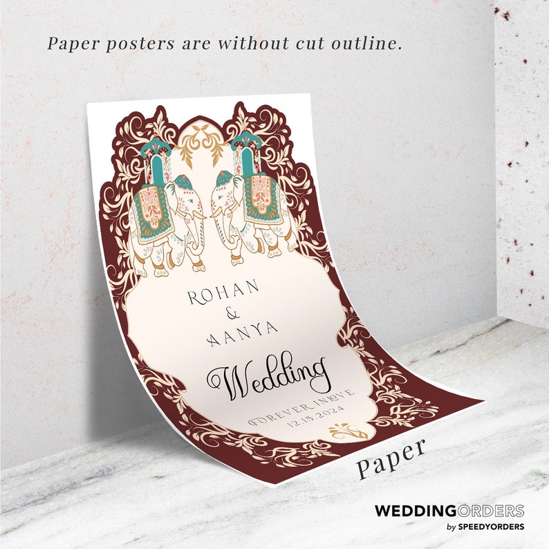 May include: A rectangular paper wedding poster featuring a deep maroon border with intricate gold filigree patterns. Two white elephants with colorful decorative blankets face each other. The text reads: ROHAN & AANYA Wedding FOREVER IN LOVE 12.15.2024.