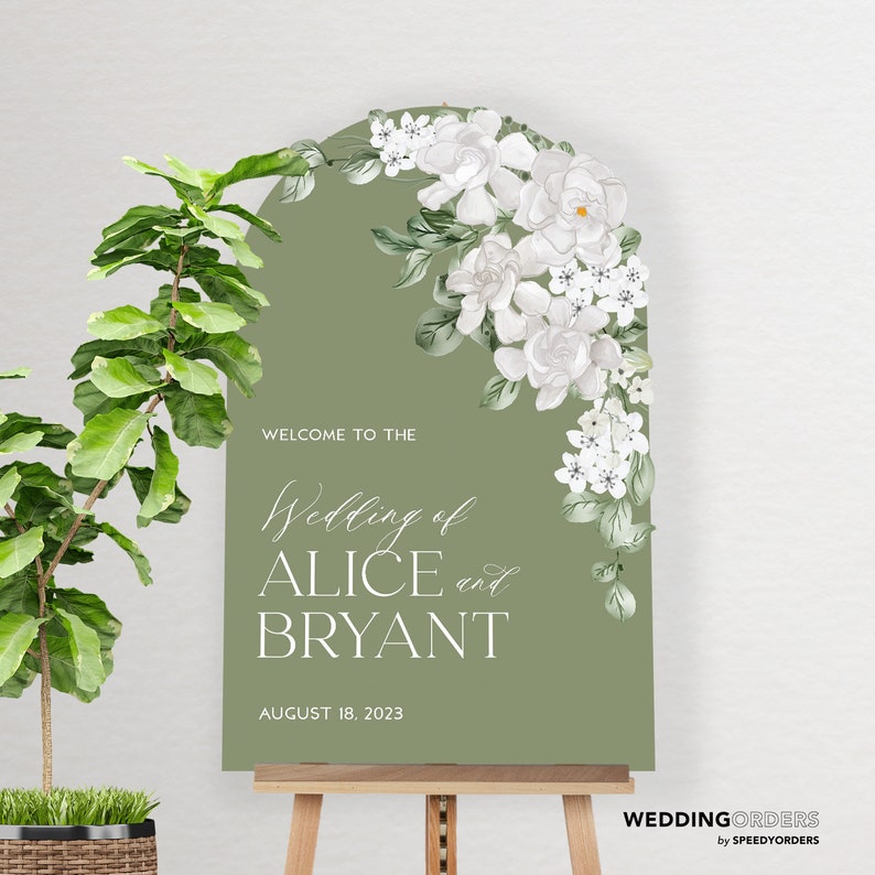 May include: An arched sage green wedding sign featuring white floral illustrations in the top right corner. The text reads: WELCOME TO THE Wedding of ALICE and BRYANT AUGUST 18, 2023. The sign is displayed on a wooden easel next to a potted plant.