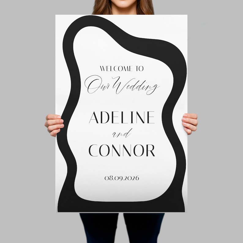 May include: A rectangular wedding sign featuring a white background with a thick, black, wavy border. The text reads: WELCOME TO Our Wedding ADELINE and CONNOR 08.09.2026. The design uses a combination of serif and script fonts in black ink.