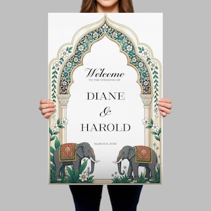 Peut inclure: Une affiche de bienvenue de mariage rectangulaire avec une arche orn&eacute;e de motifs floraux bleu sarcelle, dor&eacute;s et blancs. Le texte indique Welcome to the wedding of Diane & Harold March 6, 2026. Deux &eacute;l&eacute;phants gris avec des couvertures rouges et dor&eacute;es.