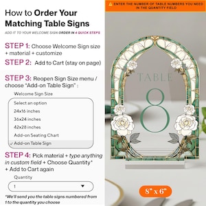 May include: An arched table sign measuring 8 by 6 inches featuring a stained glass style border in shades of green and cream with white rose illustrations. The sign displays the word TABLE and the number 8 in a dark green font on a clear surface.