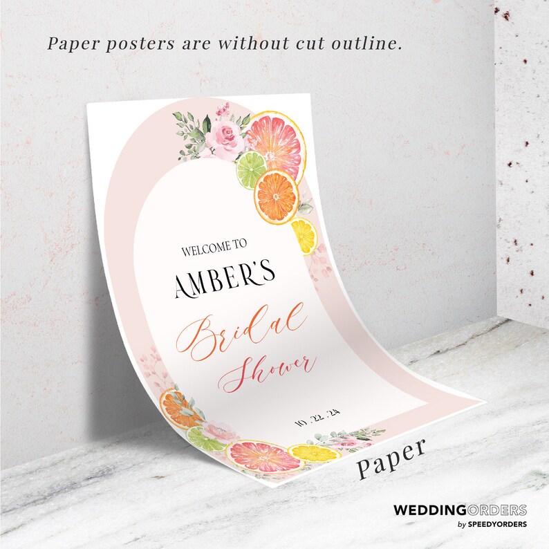 May include: A pink and white bridal shower sign with a floral design and citrus fruit accents. The sign says "Welcome to Amber's Bridal Shower" and includes the date "01.22.24".