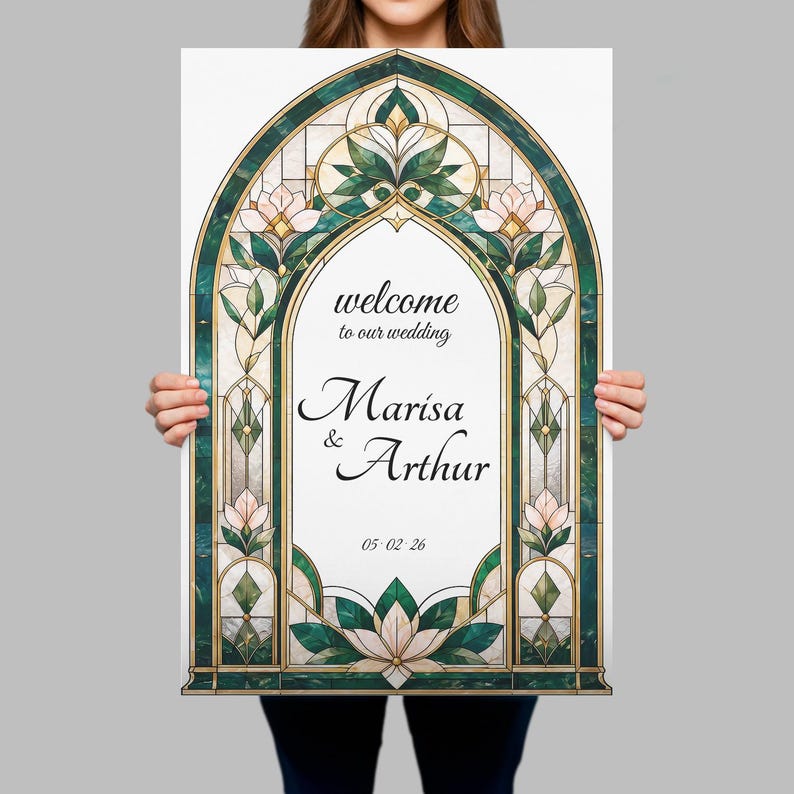 May include: A rectangular wedding welcome sign featuring an arched stained glass border in shades of emerald green and cream with floral motifs. The center text reads: welcome to our wedding, Marisa & Arthur, and the date 05.02.26 in black script.