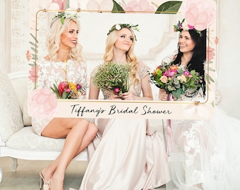 May include: A photo booth prop with a floral design and gold frame. The text "Tiffany's Bridal Shower" is printed on the bottom of the frame.