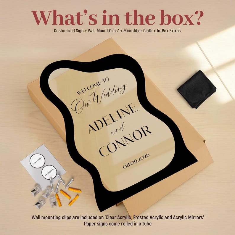 May include: A wavy-edged, clear acrylic wedding sign featuring black text that reads: WELCOME TO Our Wedding ADELINE and CONNOR 08.09.2026. The set includes a cardboard box, wall mount clips, yellow wall anchors, and a black microfiber cloth.