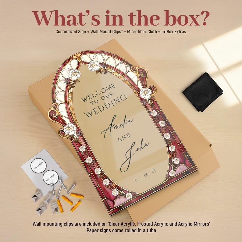 May include: A wedding sign with the text "Welcome to our Wedding" and the names "Amelia and John" is displayed. The sign has a decorative border with floral accents and the date "10.15.25". The sign is packaged with a microfiber cloth and wall mounting clips.