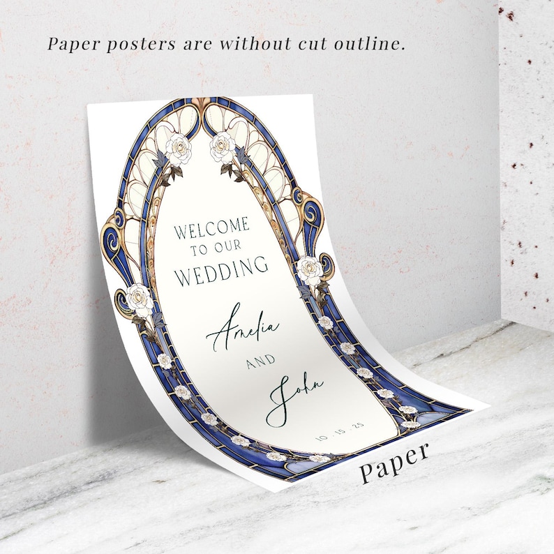 May include: A white paper wedding sign with a blue and gold arched border, featuring the text "WELCOME TO OUR WEDDING" and the names "Amelia AND John". The sign also includes the date "10-15-25" and the word "Paper".