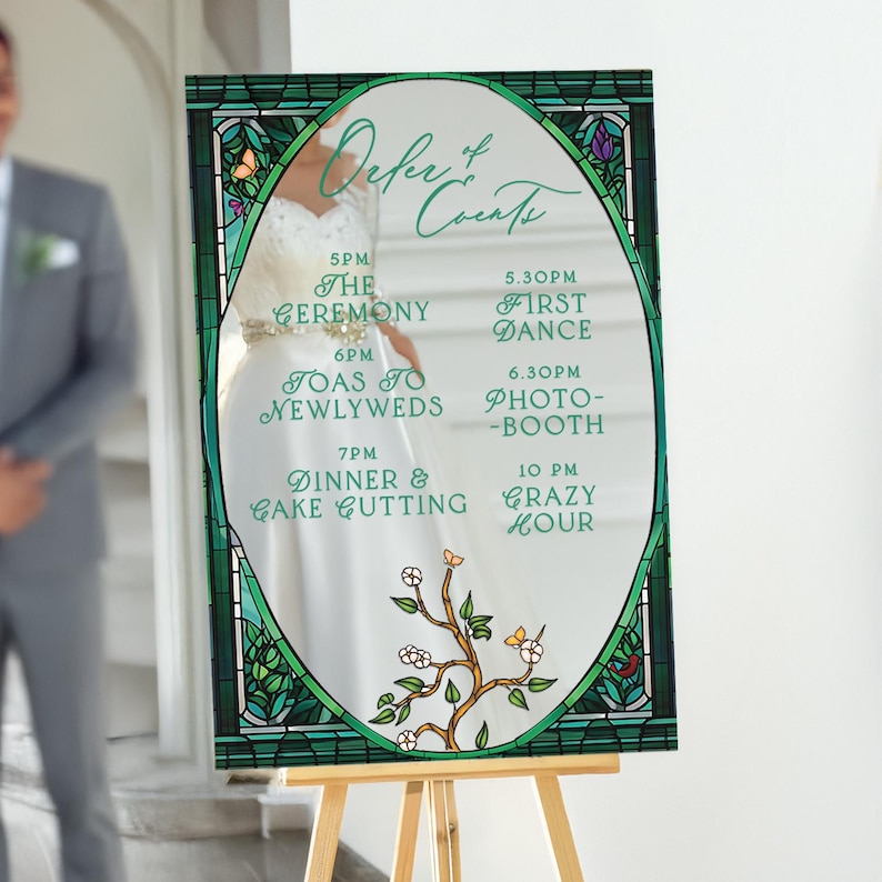 May include: A green and white wedding sign with a stained glass design. The sign lists the order of events for the wedding day, including the ceremony, toasts to the newlyweds, dinner and cake cutting, and a crazy hour.