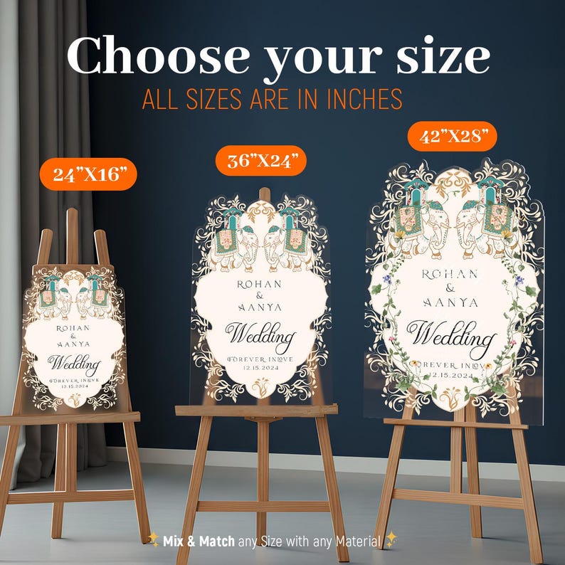 May include: Three clear acrylic wedding signs on wooden easels, labeled 24x16 inches, 36x24 inches, and 42x28 inches. Each sign features an ornate border with two elephants, floral motifs, and the text Rohan & Aanya Wedding Forever Inove 12.15.2024.