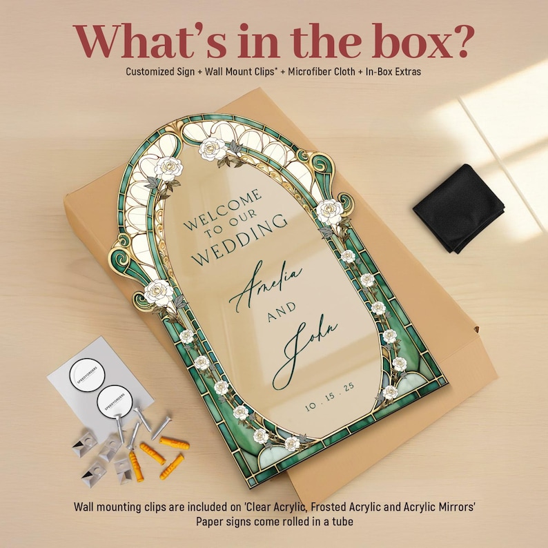 May include: A rectangular wedding sign with an arched top, featuring a green and gold stained glass-style border with white roses. The text reads: Welcome to our wedding, Amelia and John, 10.15.25. Includes wall mount clips, screws, and a cloth.