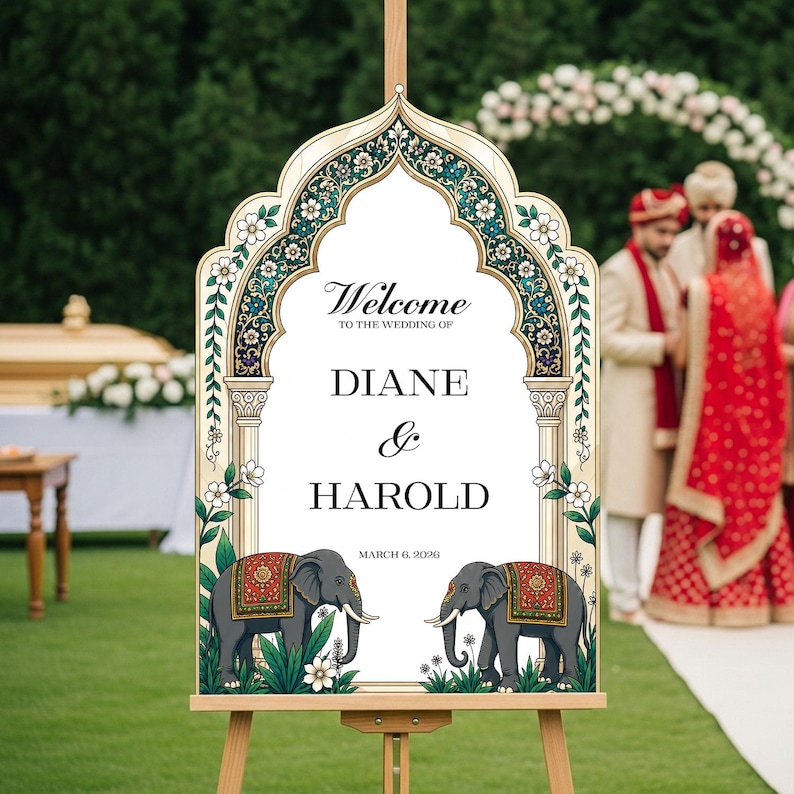 Peut inclure: Un panneau de bienvenue de mariage avec un cadre en arc orn&eacute; de motifs floraux turquoise et dor&eacute;s. Le texte indique Welcome to the wedding of Diane & Harold March 6, 2026. Deux &eacute;l&eacute;phants gris avec des couvertures d&eacute;coratives rouges et dor&eacute;es.