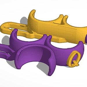 May include: Two 3D printed phone holders, one purple and one gold, with the letter "Q" on each.