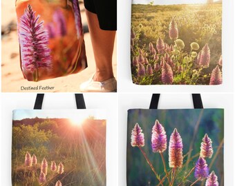 May include: Four tote bags featuring different close-up photographs of pink wildflowers in a field. The bags are white with black handles. The text "Destined Feather" is printed on one of the bags.