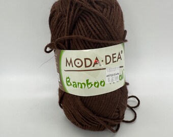 May include: A brown ball of yarn labeled "Moda Dea Bamboo" with the price tag "$6.99" and the words "ARTCO Crafts" on it.