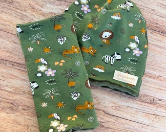 Green baby eraser and neck warmer with savannah animals.