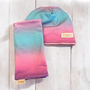 Girls&#39; and women&#39;s hats with shades of pink, lilac, and blue. A cotton hat and neck warmer or scarf set for girls.