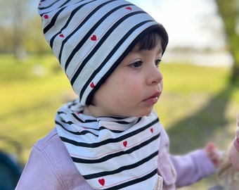 Baby girl's hat in black and white striped cotton with red hearts. Coordinated baby girl hat and bib bandana.