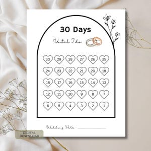 Puede incluir: Un calendario de cuenta regresiva de boda imprimible en blanco con el texto "30 días hasta que me case". El calendario presenta una cuadrícula de cuenta regresiva en forma de corazón, un elemento floral decorativo y un espacio para la fecha de la boda. Se muestran dos anillos de boda en la parte superior.