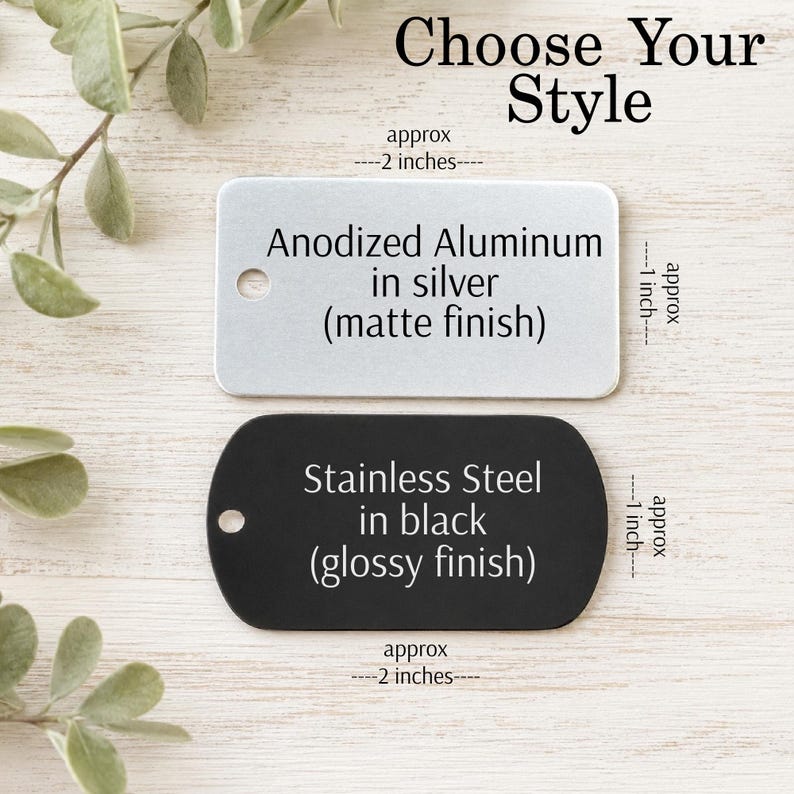 May include: Two metal tags, one silver and one black, with text. The silver tag, approximately 2 inches long and 1 inch wide, reads "Anodized Aluminum in silver (matte finish)." The black tag, also about 2 inches long and 1 inch wide, says "Stainless Steel in black (glossy finish)." The text "Choose Your Style" is at the top.