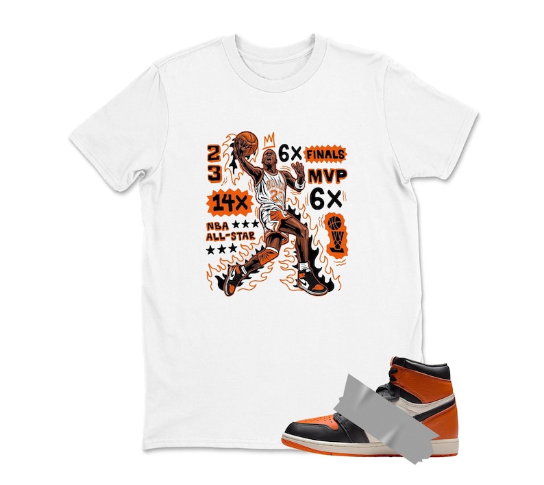 May include: White t-shirt with an orange and black graphic of a basketball player in action, with text that reads "23", "14x NBA All-Star", "6x Finals", and "MVP 6x". A black, white, and orange high-top sneaker is in the foreground.