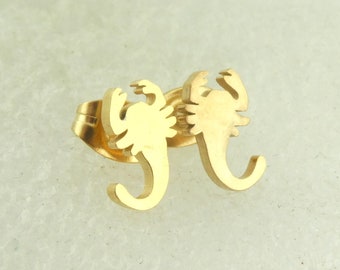 May include: A pair of gold-toned scorpion stud earrings.