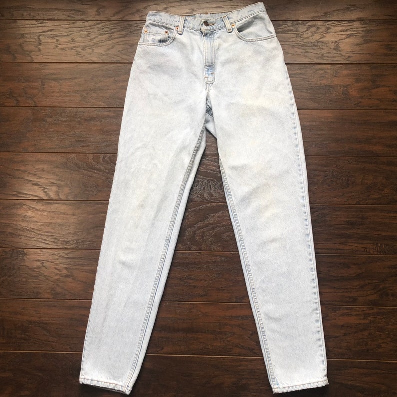 May include: Light blue denim jeans with a high waist and a straight leg fit.