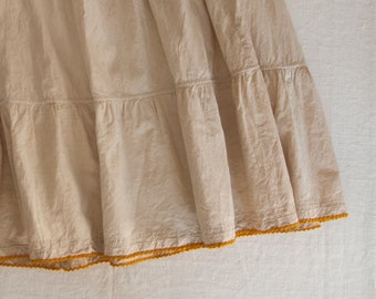 Old and very long ecru cotton skirt with handmade crochet lace. 1900s.