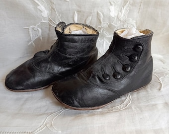 Antique baby booties. Black leather and buttoned. Perfect for antique doll. End of the 19th century