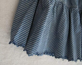 Old thick cotton skirt, with blue stripes and handmade festoons. 1900s.