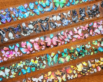 May include: A roll of clear tape featuring colourful butterfly designs. The butterflies are in a variety of colours, including blue, pink, green, and yellow.