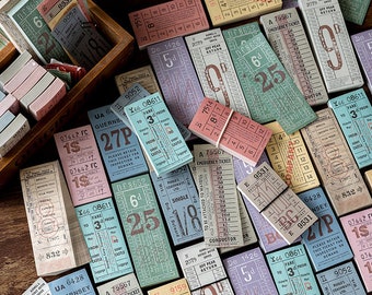 May include: A collection of vintage-style ticket-shaped paper ephemera with various colors, designs, and text. The tickets feature numbers, words, and phrases like "Emergency Ticket", "Off Peak Return", "Fare", and "To Be Attached To Waybill".