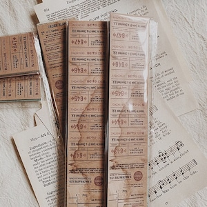 May include: A close-up of a set of vintage-style brown paper labels with the text "Services Barcelona" and a series of numbers. The labels are printed with a distressed, aged look, giving them a rustic charm.