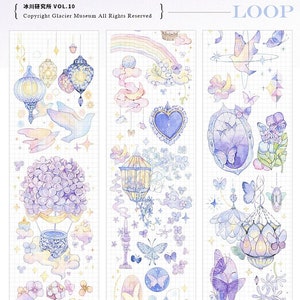 May include: Purple Dream illustrated masking tape set with a whimsical design featuring a hot air balloon, butterflies, and lanterns. The tape is 6 cm wide and 10 m long. It is made with glossy ink and includes release paper. The tape is available in two versions: one with a 3D crystal emboss and one without.