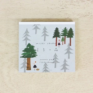 May include: A memo pad featuring a forest scene with a girl in a forest with trees and stars. The memo pad has 120 sheets and is a cozyca products product.